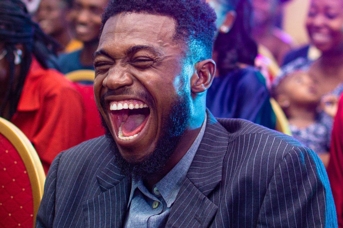 A man laughing in a comedy audience